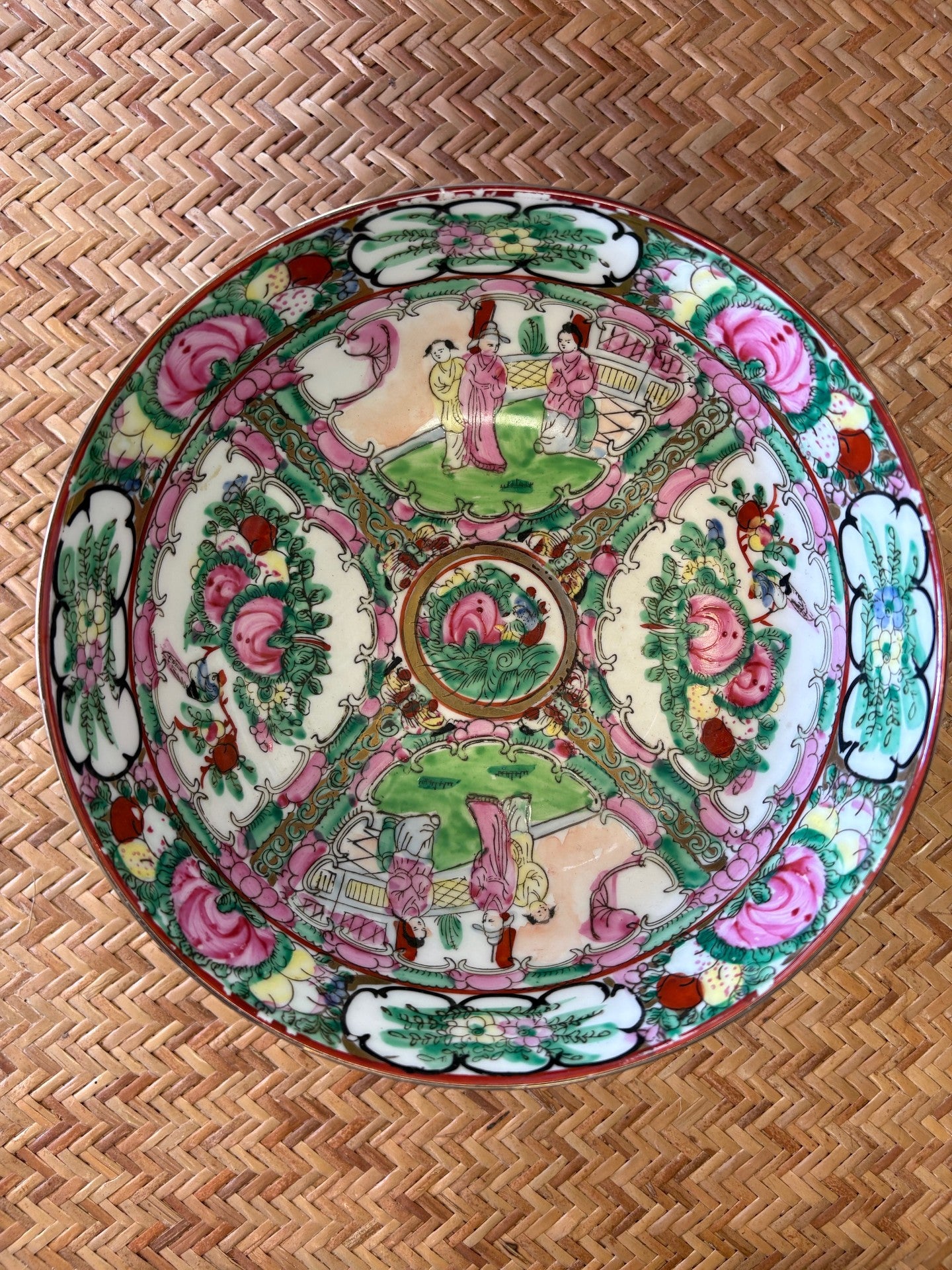 Decorative plate with colorful patterns on a woven surface