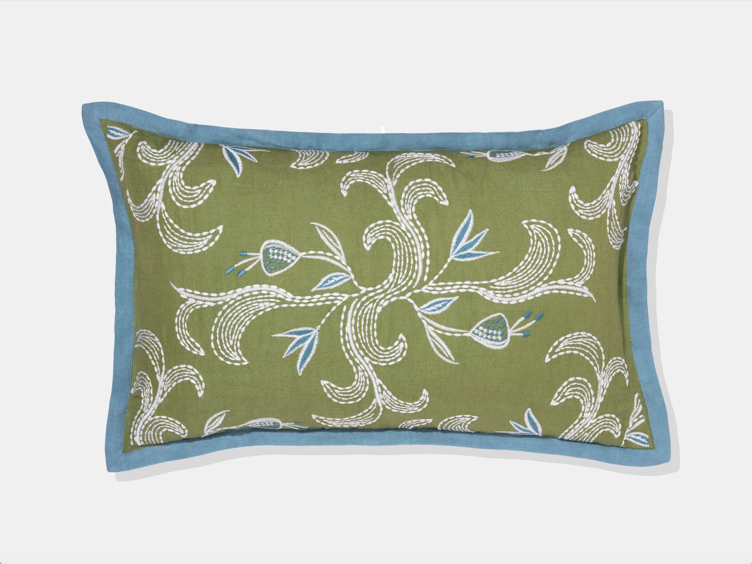 embroidered green pillow with blue flange