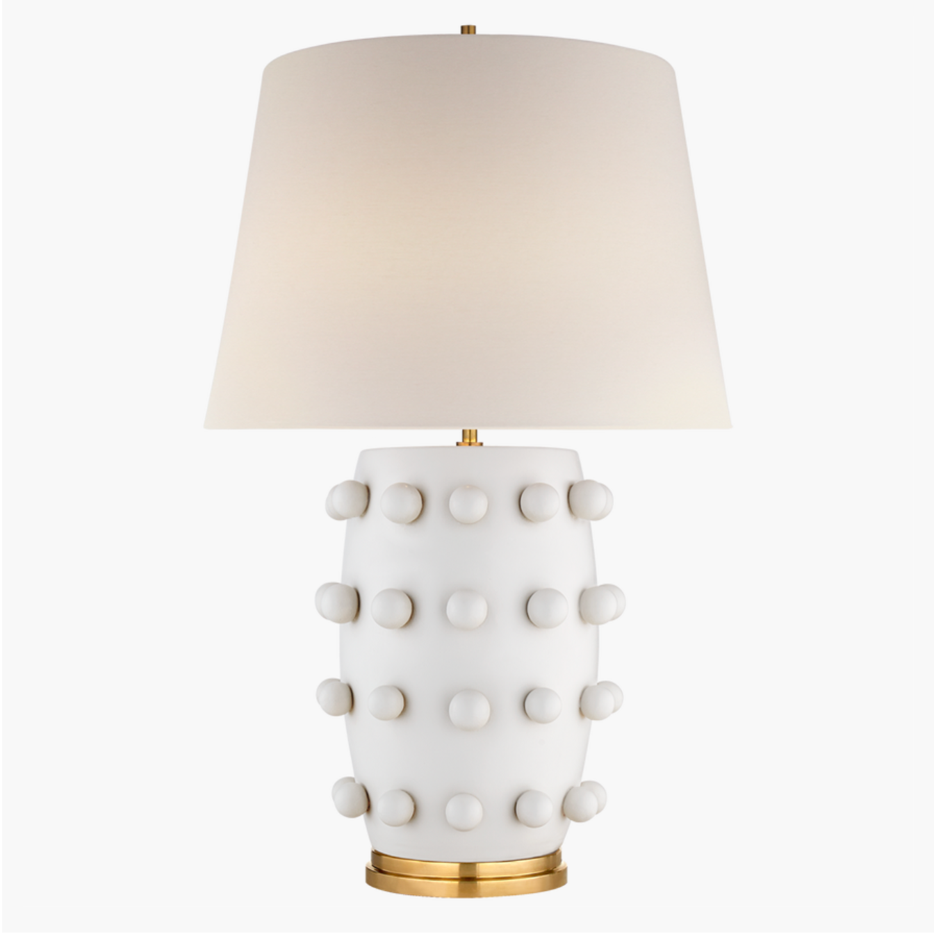 plaster white ceramic lamp with brass details and a linen shade