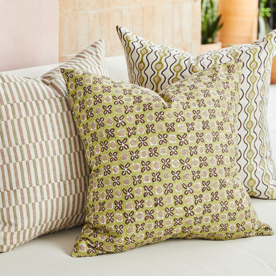 trio of square pillows on sofa
