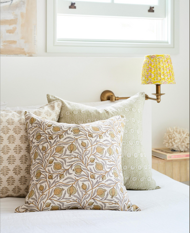 collection of decorative pillows on bed