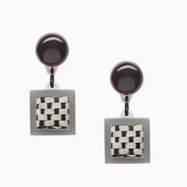 front view of pair of black and white acrylic and raffia earrings