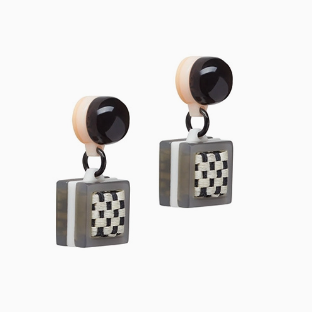 angled view of pair of black and white earrings