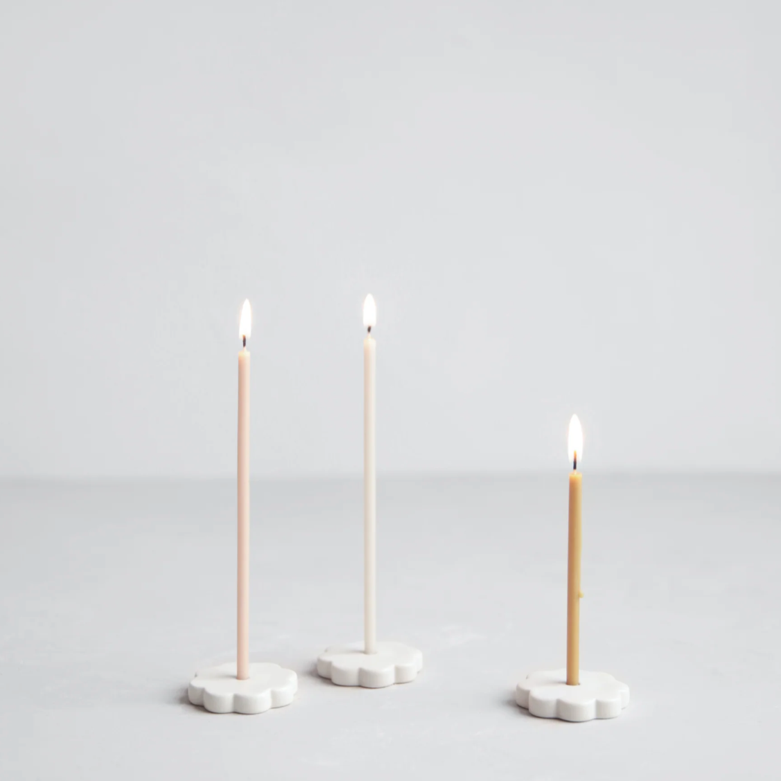 wishing candles in flower-shaped candleholders