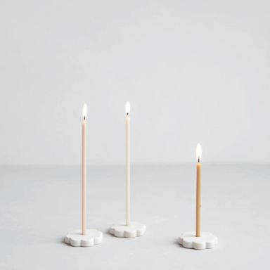 wishing candles in flower-shaped candleholders