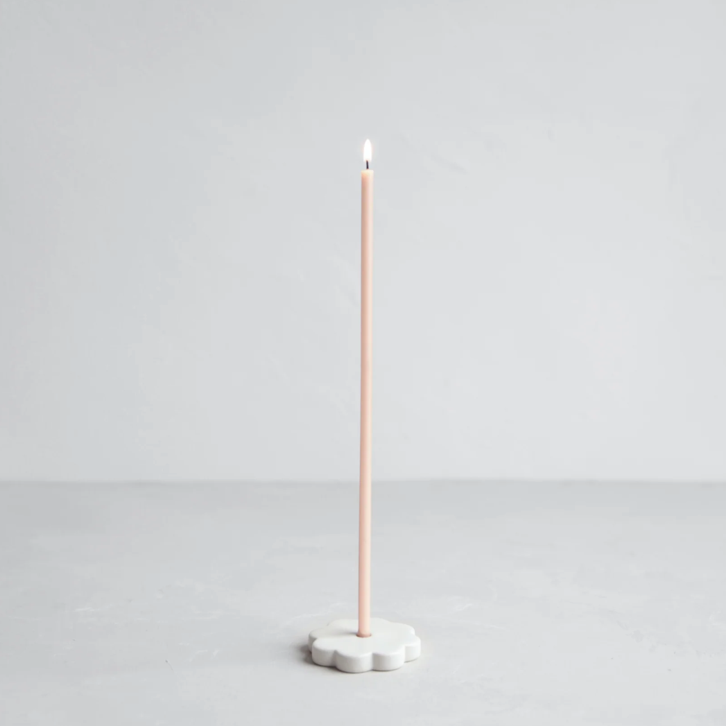 single taper candle in ceramic candleholder