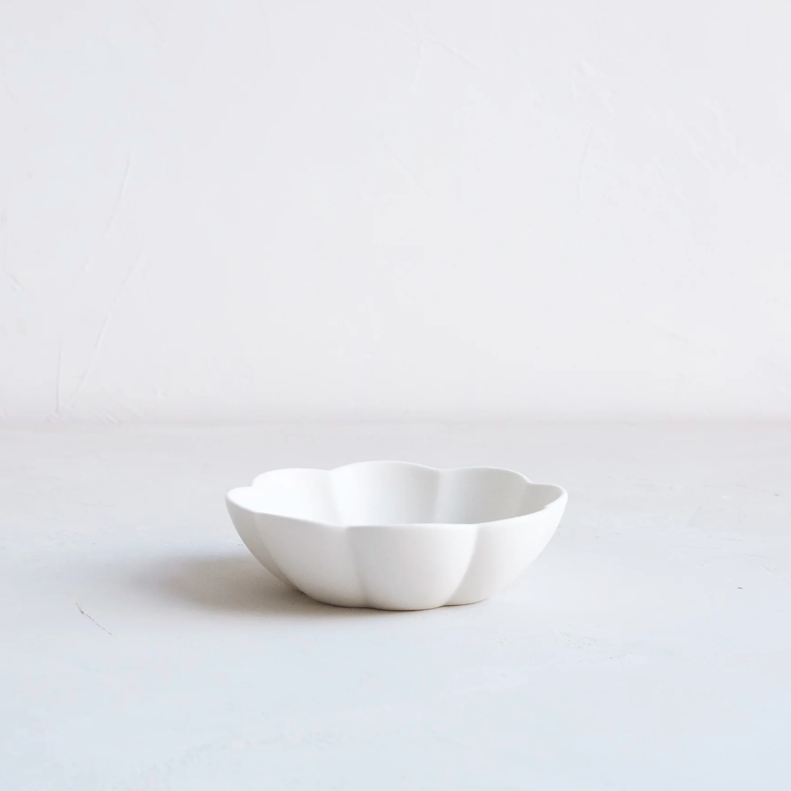 white ceramic flower-shaped small dish