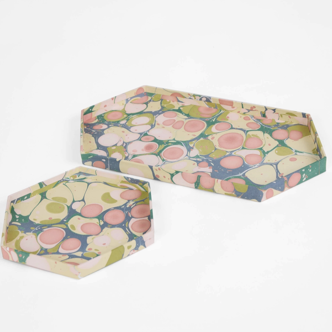 two sizes of pink and green hexagonal shallow paper trays