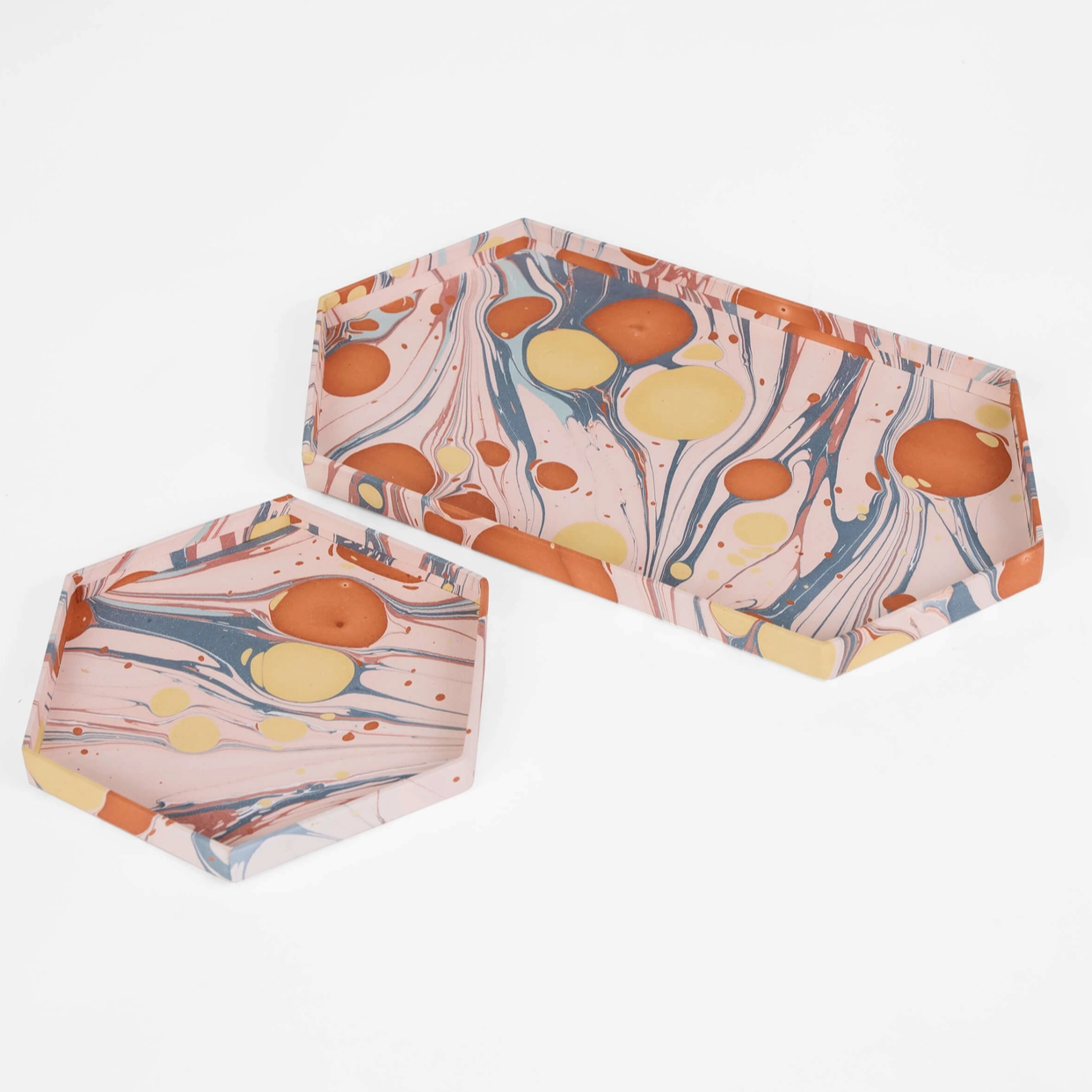 pink, red and yellow shallow paper trays