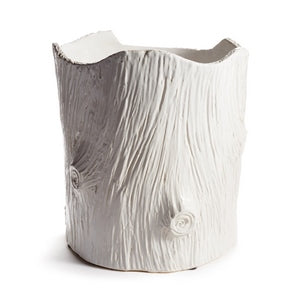White ceramic vase with textured surface on a white background