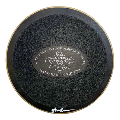 Round black disk with 'John Derian' branding on a white background