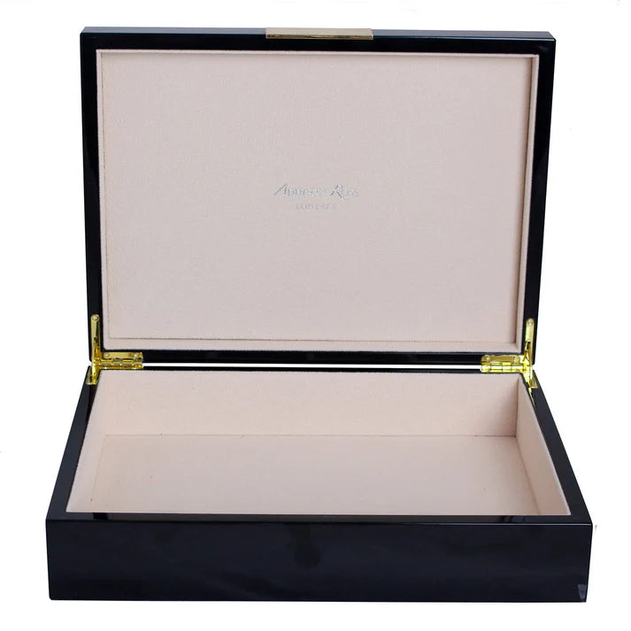 Black wooden jewelry box with beige interior on a white background