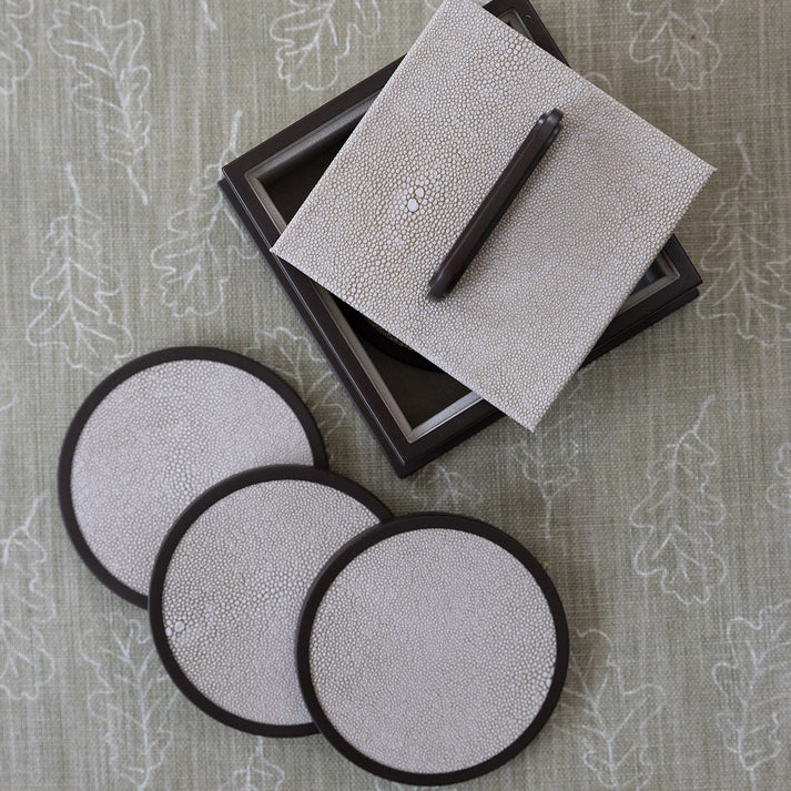 Set of shagreen coasters and notebook on a textured surface