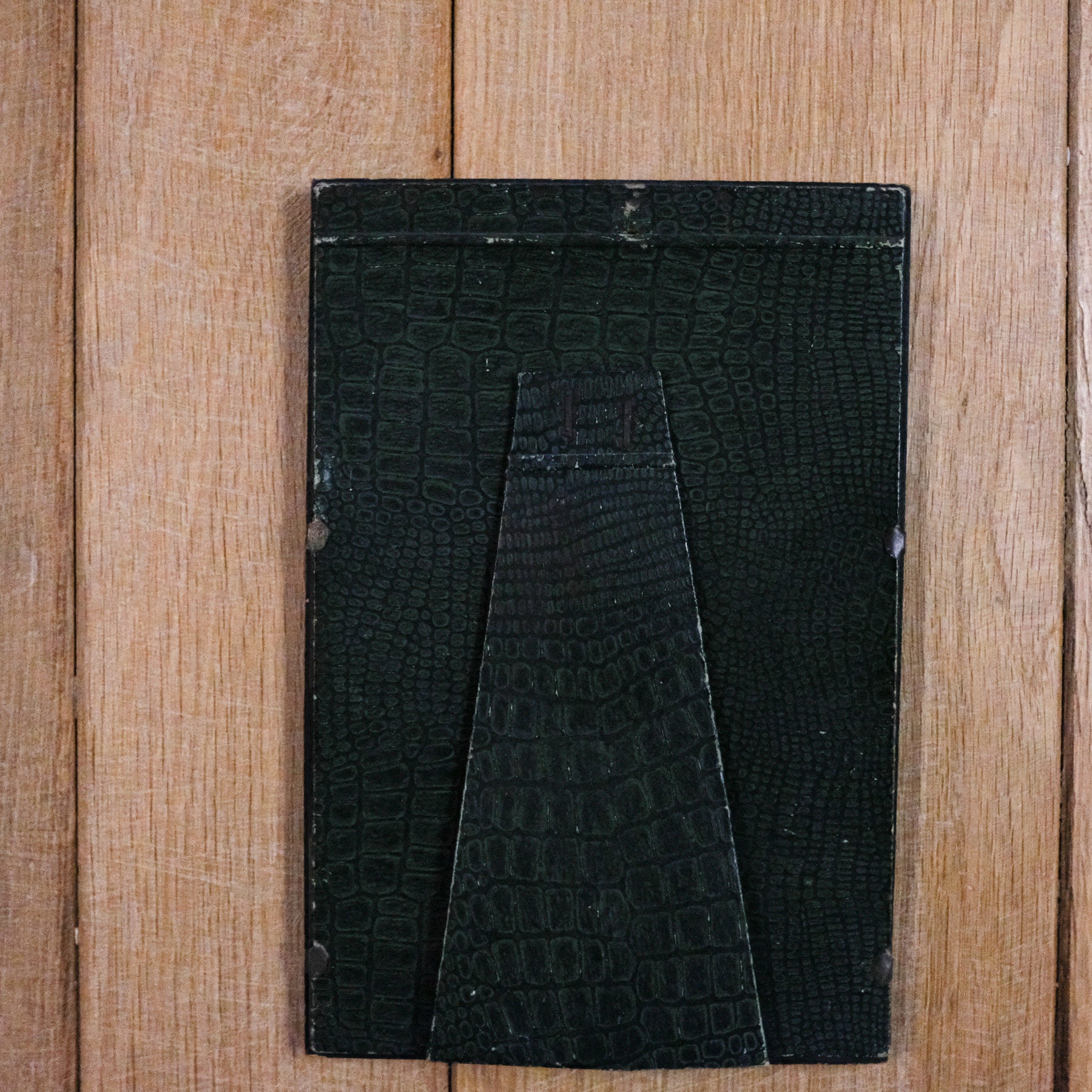 green leather back of vintage frame
