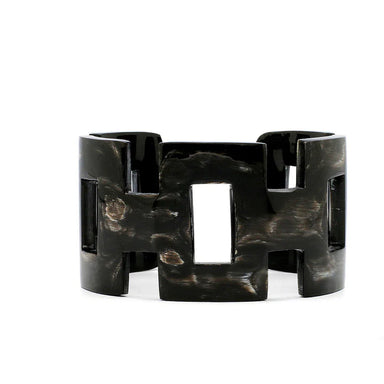 Black tortoiseshell bracelet on a white background