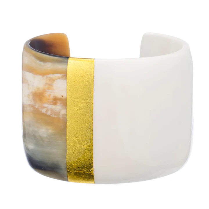 Ceramic bracelet with gold band on a white background