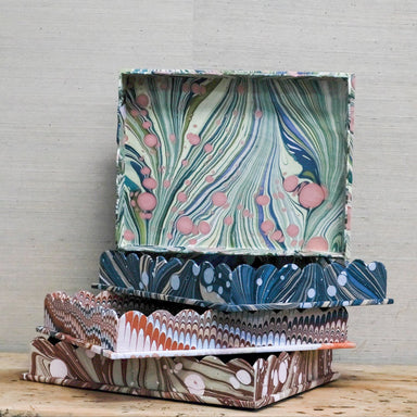 stack of marbleized paper trays with scallop edge