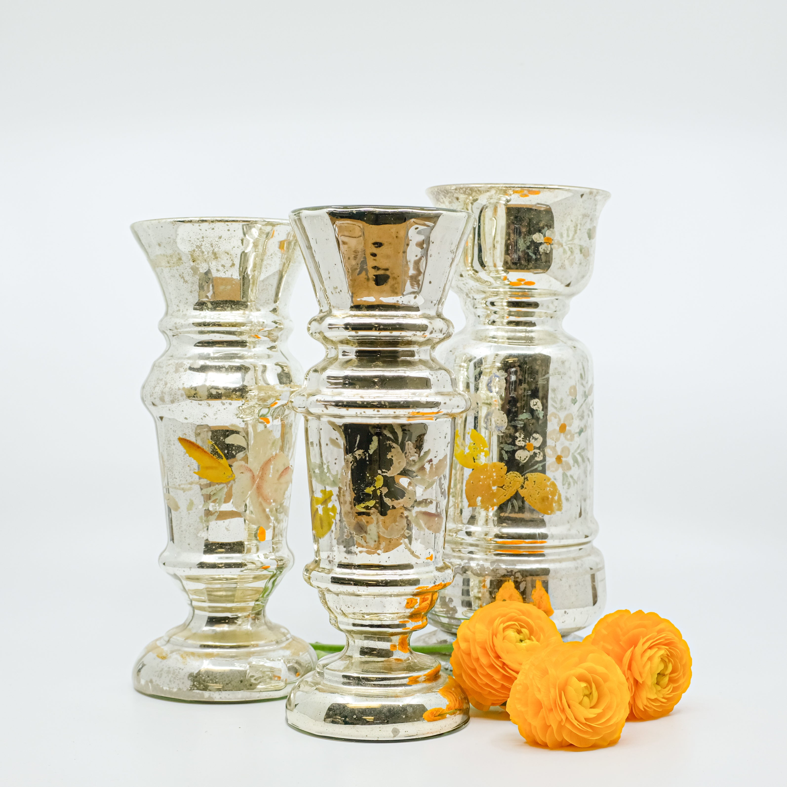 trio of mercury glass vases with ranunculuses
