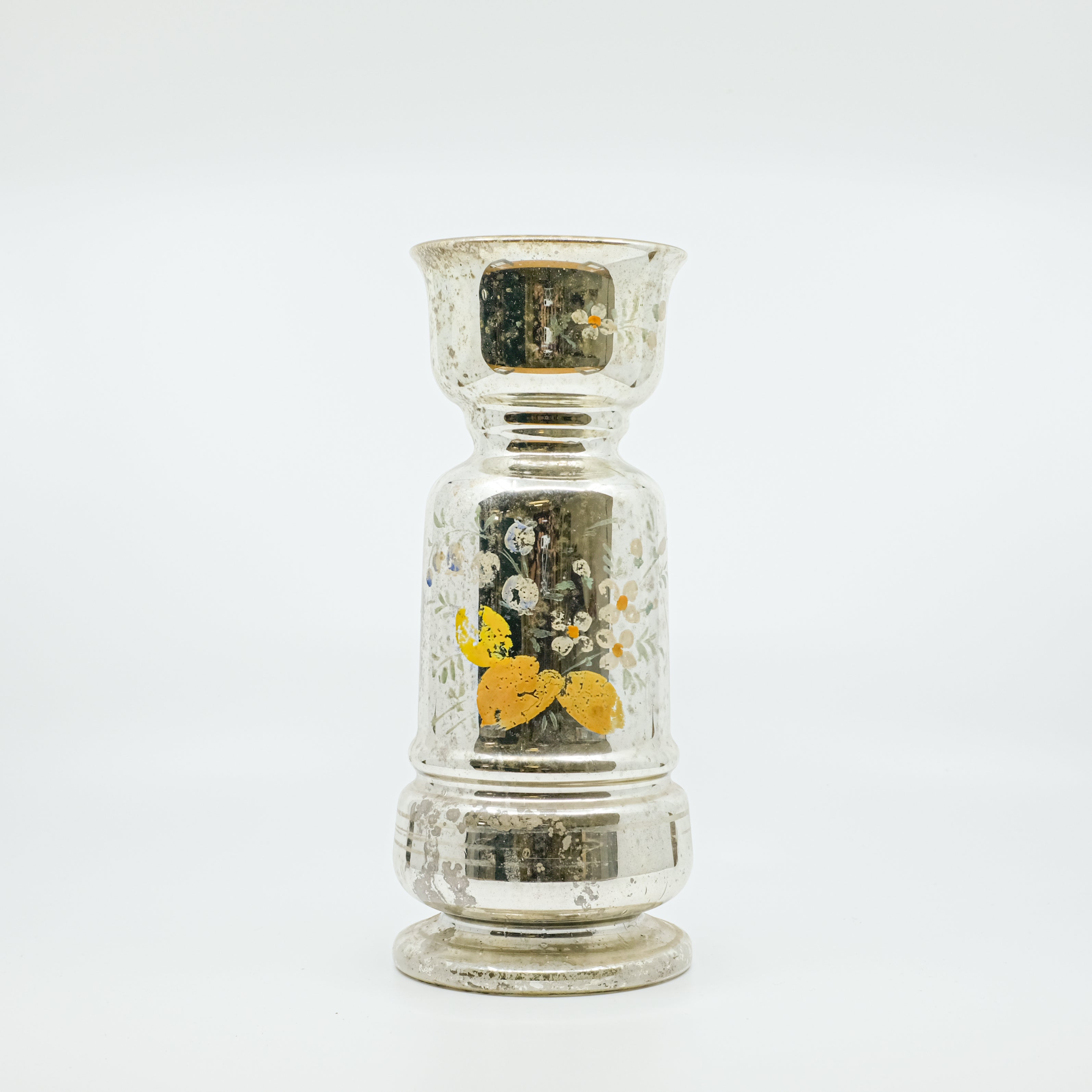 mercury glass vase with faded orange and white flowers