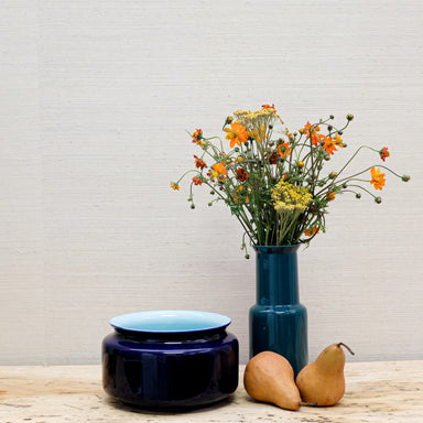 glossy vases with flowers and pears