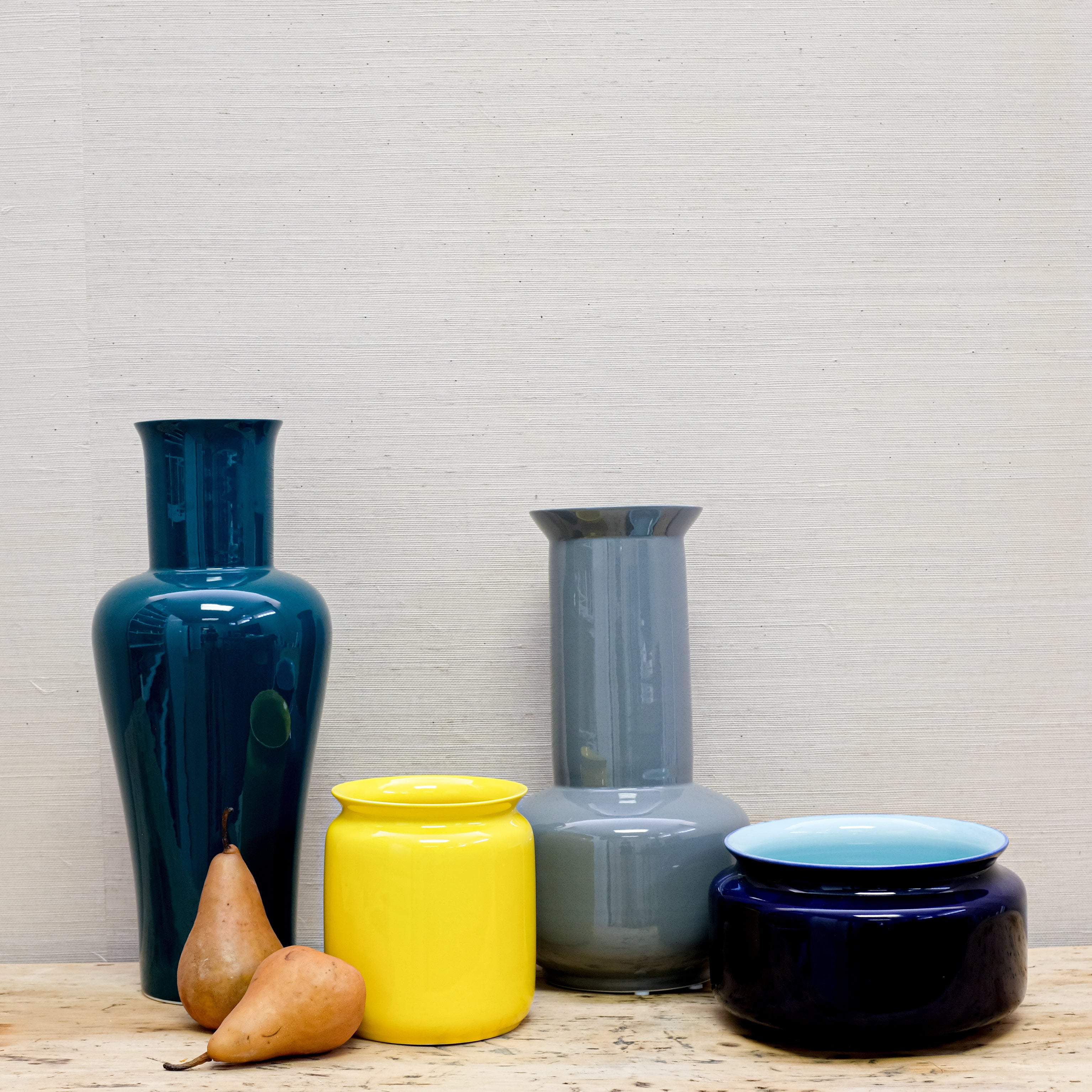 a collection of glossy vases