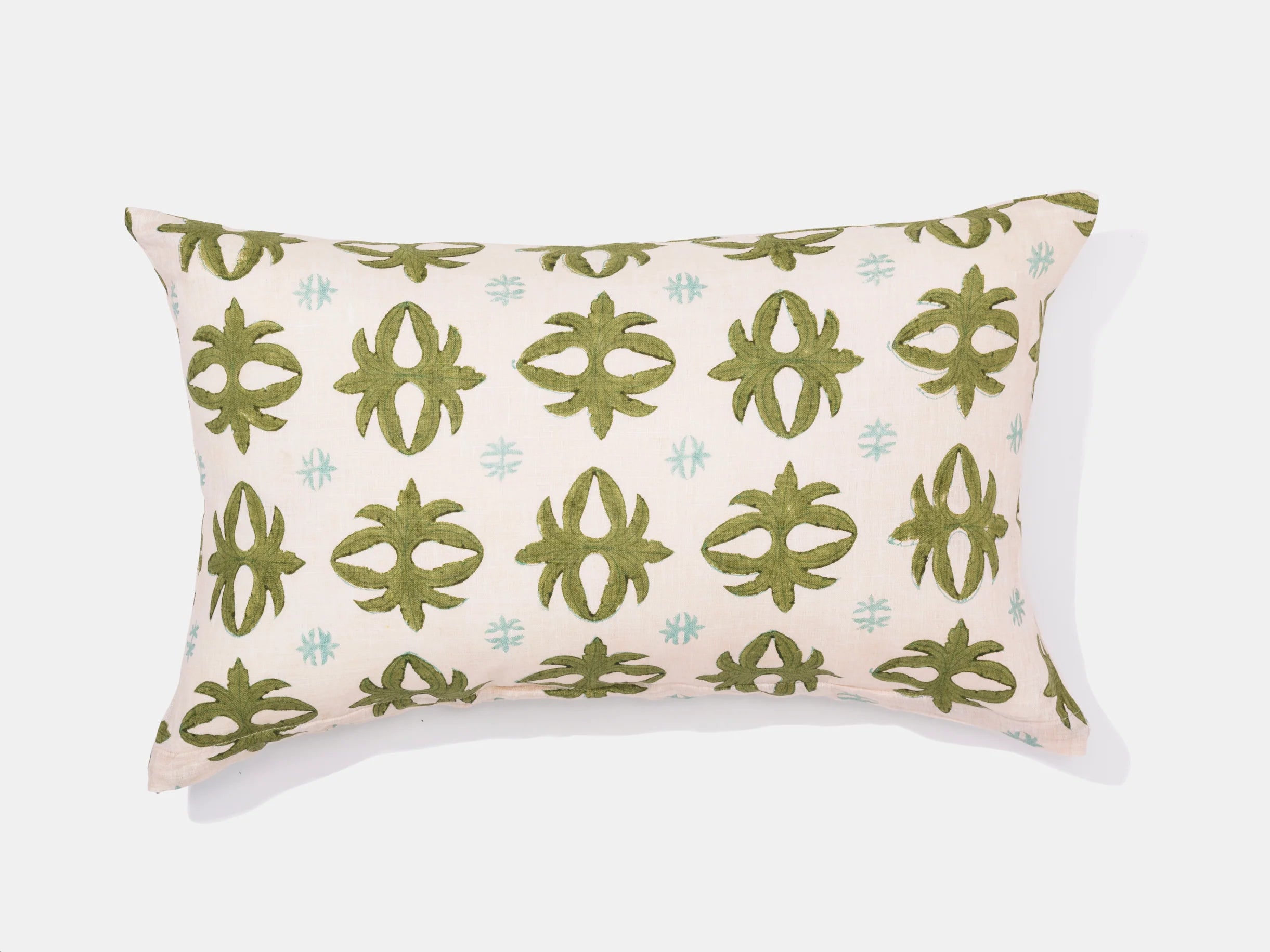 geometric green fleur de lis on white pillow