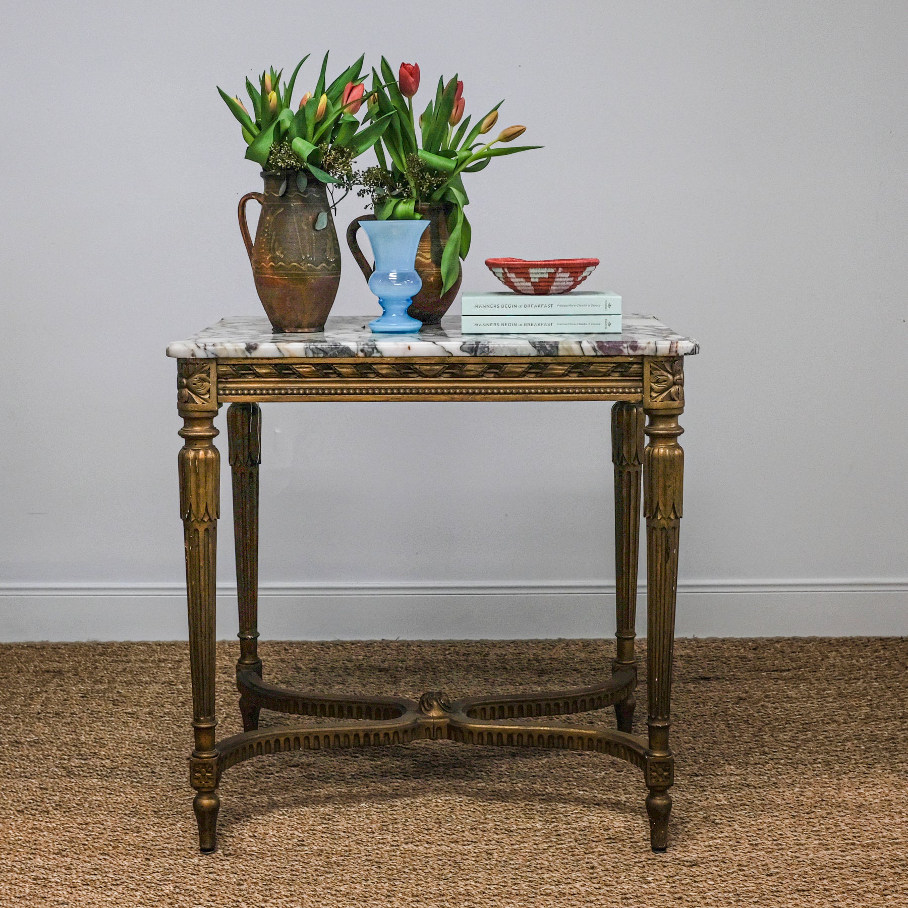 antique marble-top table with gold legs set with pottery