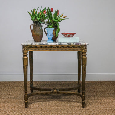 antique marble-top table with gold legs set with pottery