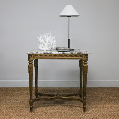 marble-top antique table set with lamp and white coral