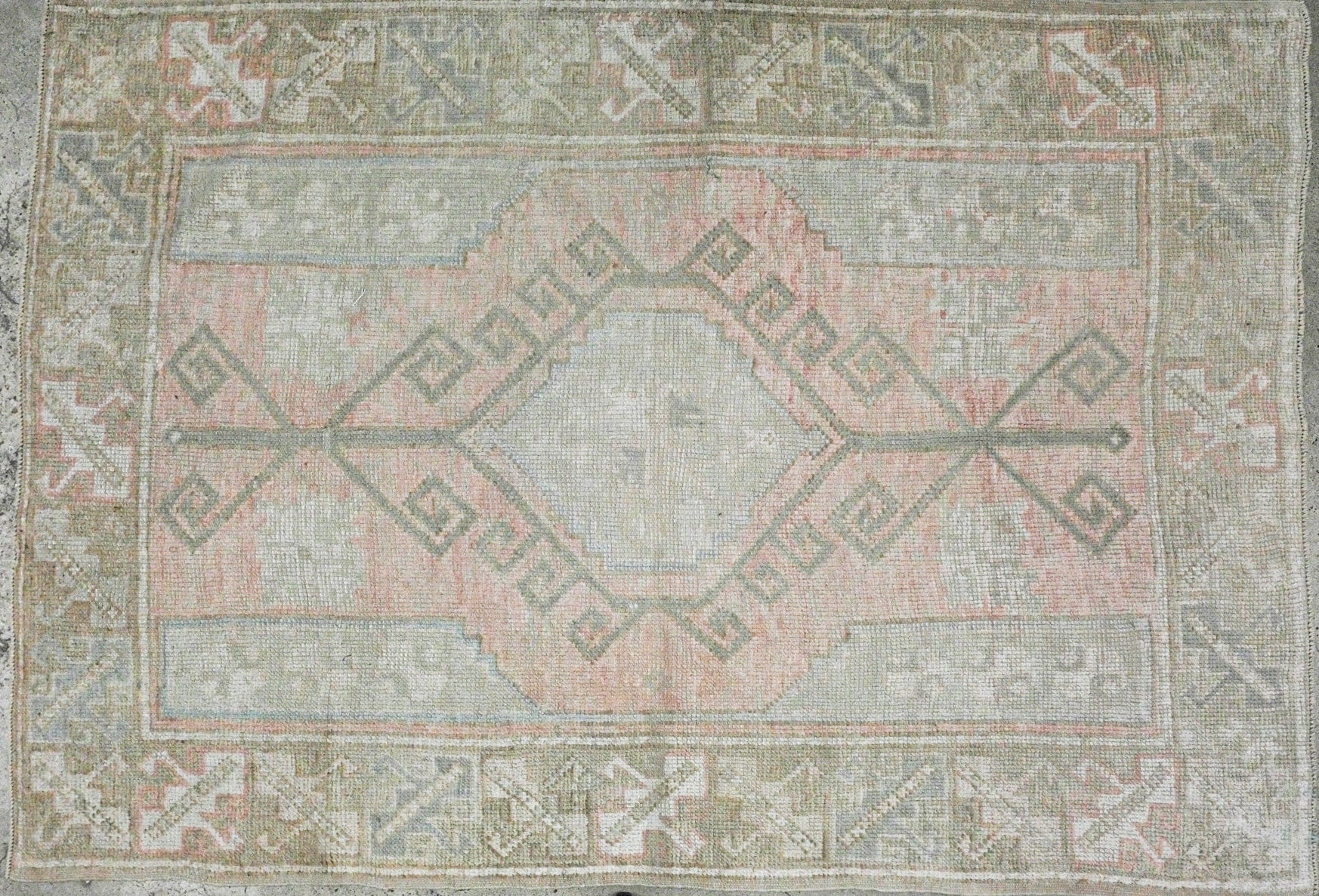 pale pink oushak with pale blue accent line