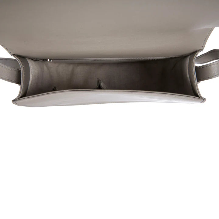Close-up of a gray handbag with a white background