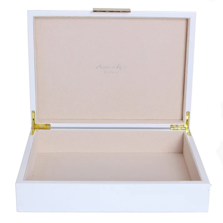 White jewelry box with gold hinges on a white background