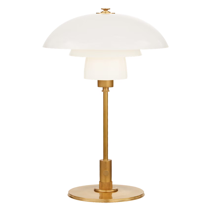 Table lamp with white shade and gold base on a white background