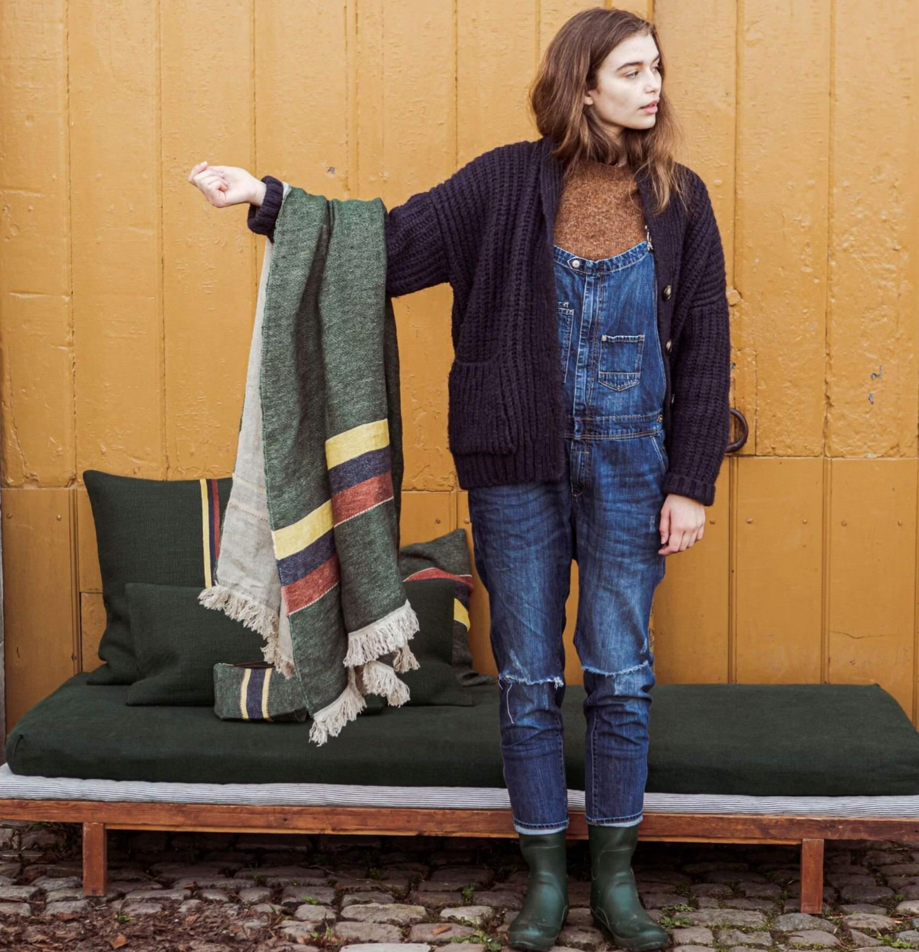 woman holding a Belgian linen towel on her arm to show the size and color
