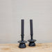 green-black candles in black pottery candleholders
