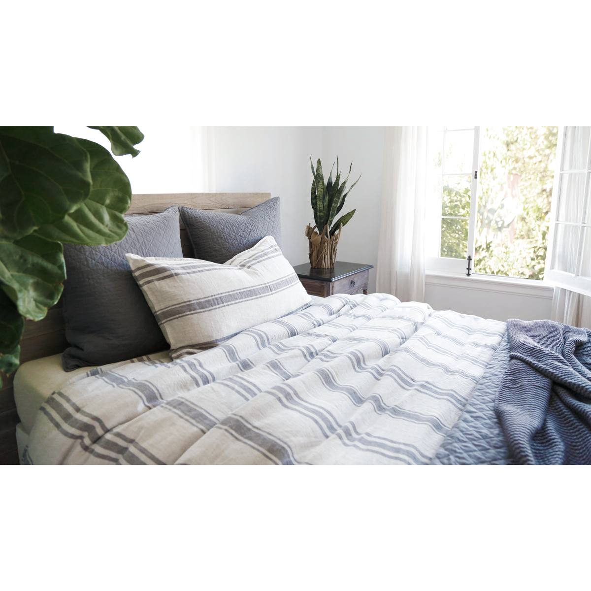 grey stripe linen duvet cover and shams on bed with dark grey Euro shams, throw and coverlet