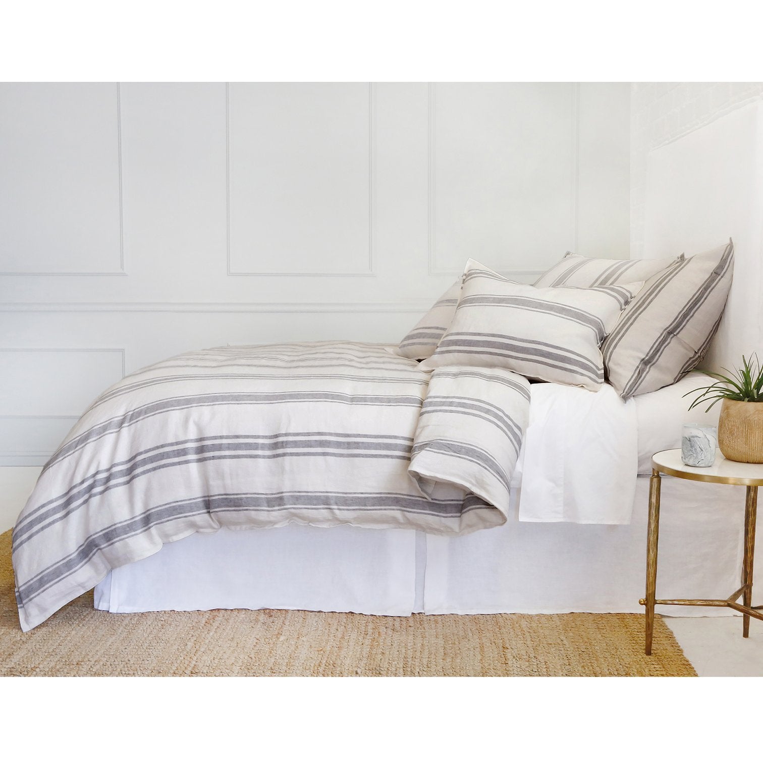 side view of linen striped duvet cover and shams on bed