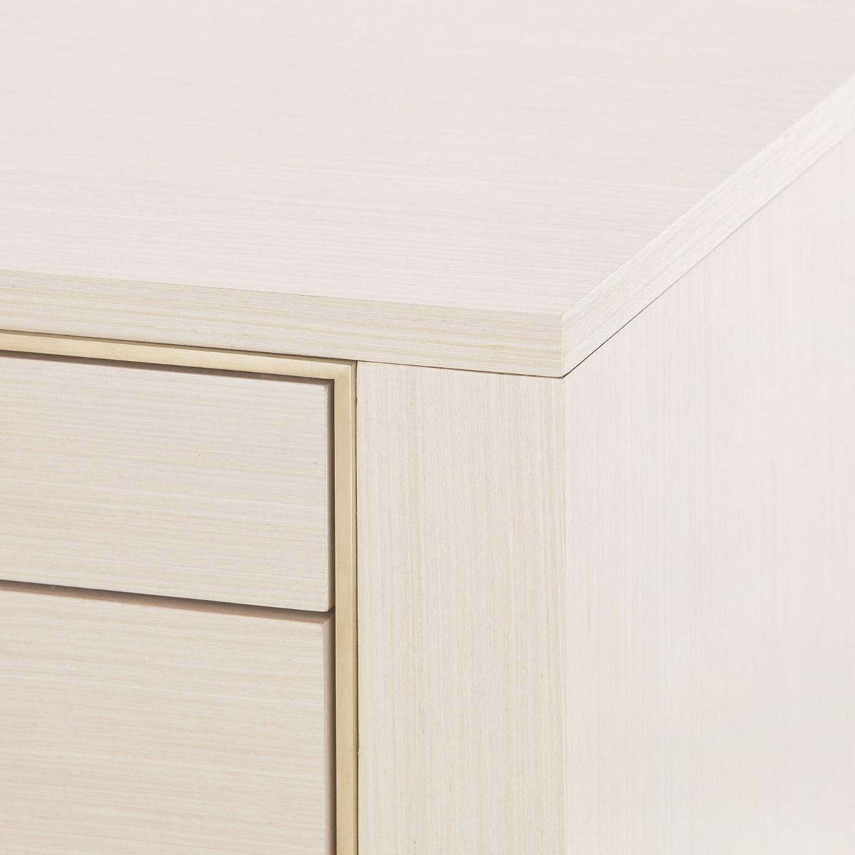 edge detail of desk in oak and brass