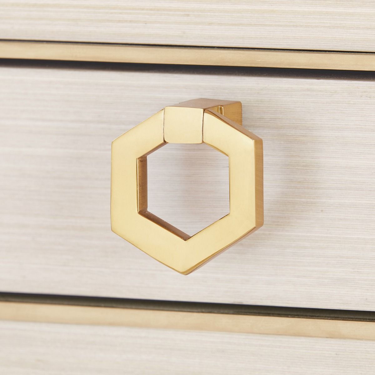 brass pull detail on desk drawer