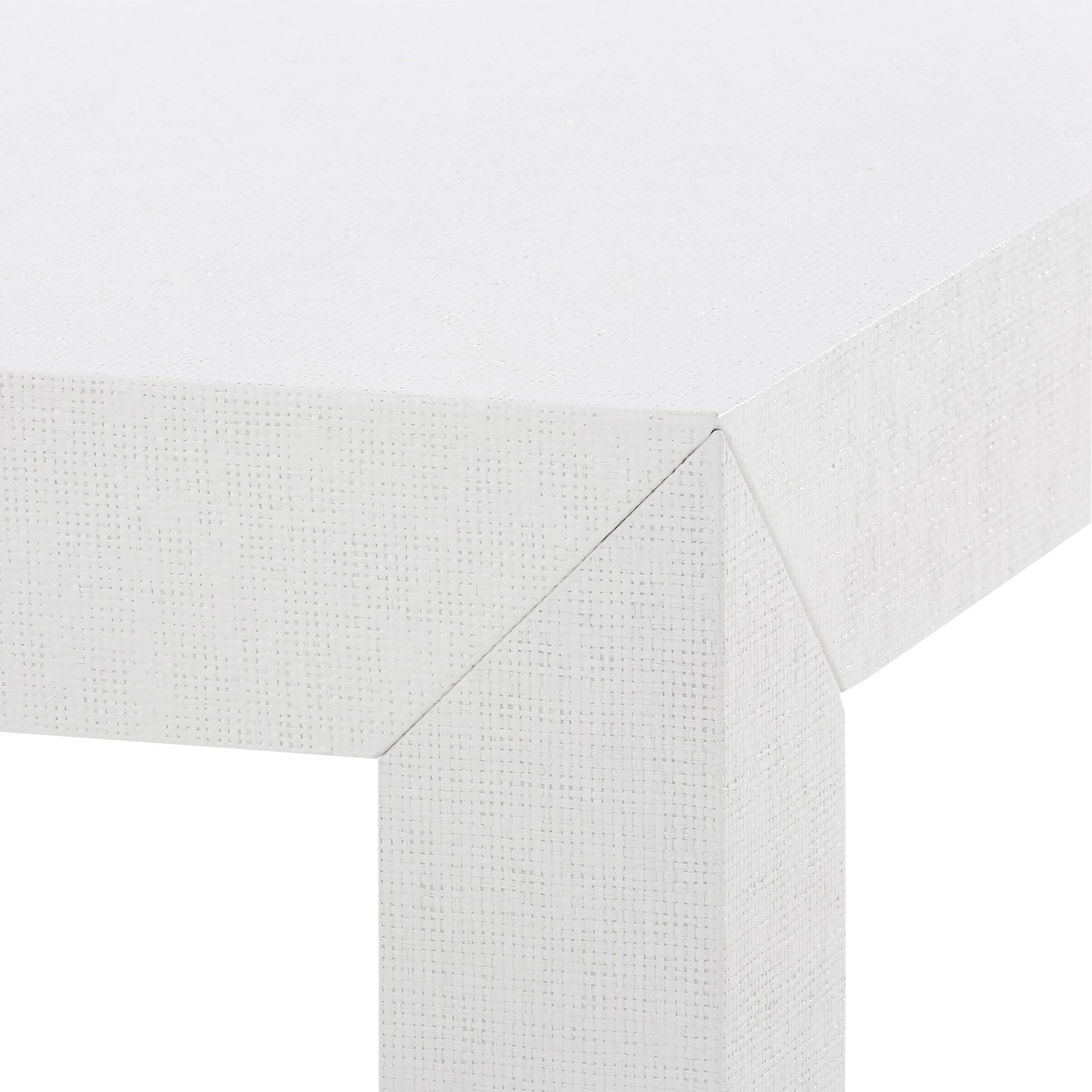 corner detail of white grasscloth cocktail table