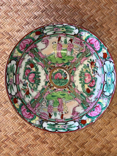 Decorative plate with colorful patterns on a woven surface