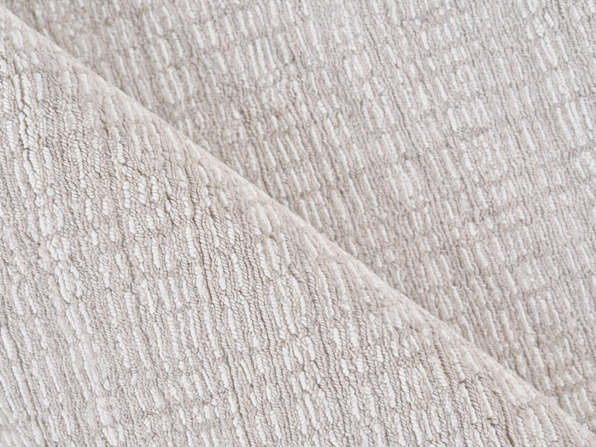 Close-up of textured soft taupe rug