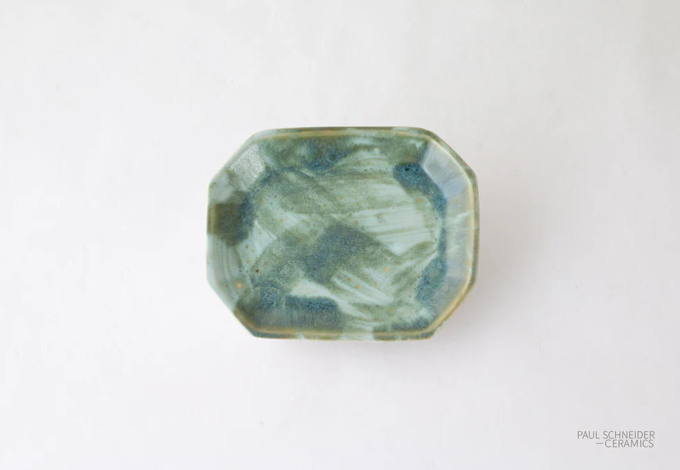Green ceramic dish on a white background