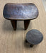 Two wooden stools on a carpeted floor