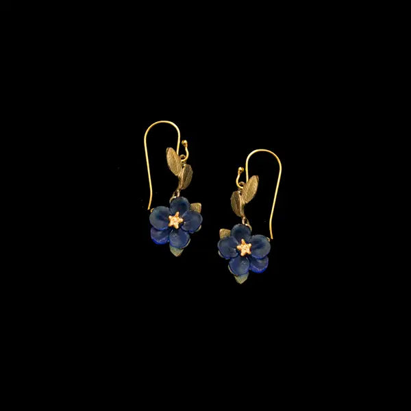 Pair of floral earrings with blue flowers and gold accents on a black background