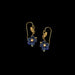 Pair of floral earrings with blue flowers and gold accents on a black background