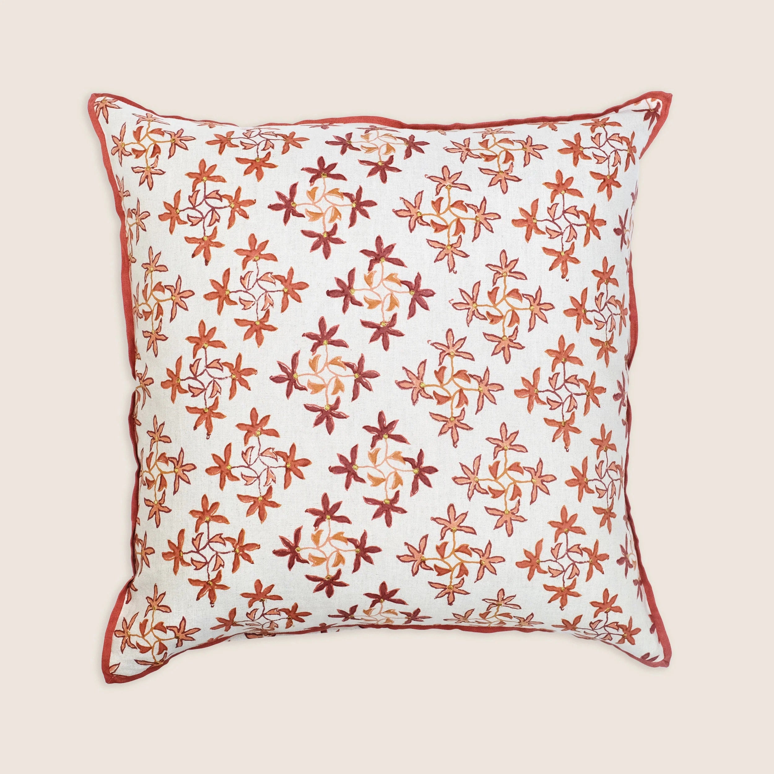 Decorative pillow with floral pattern on a beige background