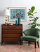 Italian chest of drawers with abstract art and green velvet chair