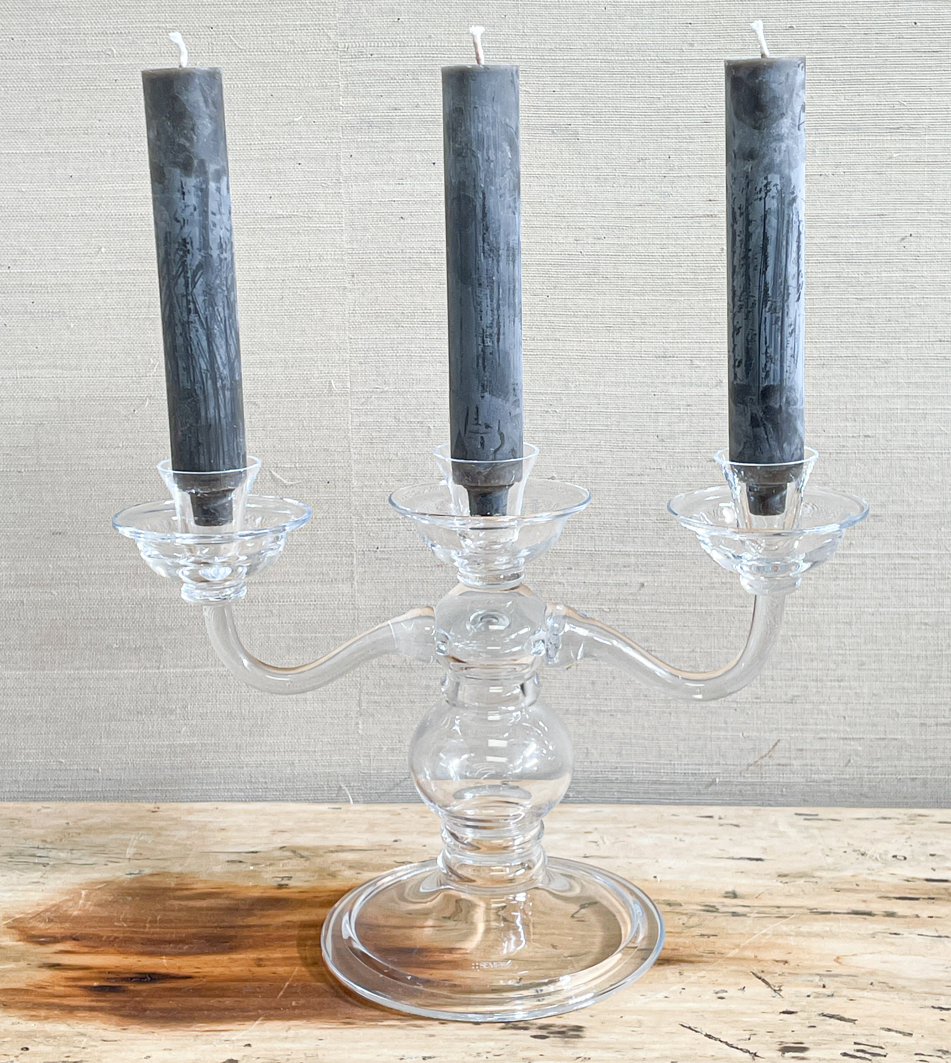 glass candelabra with dark candles