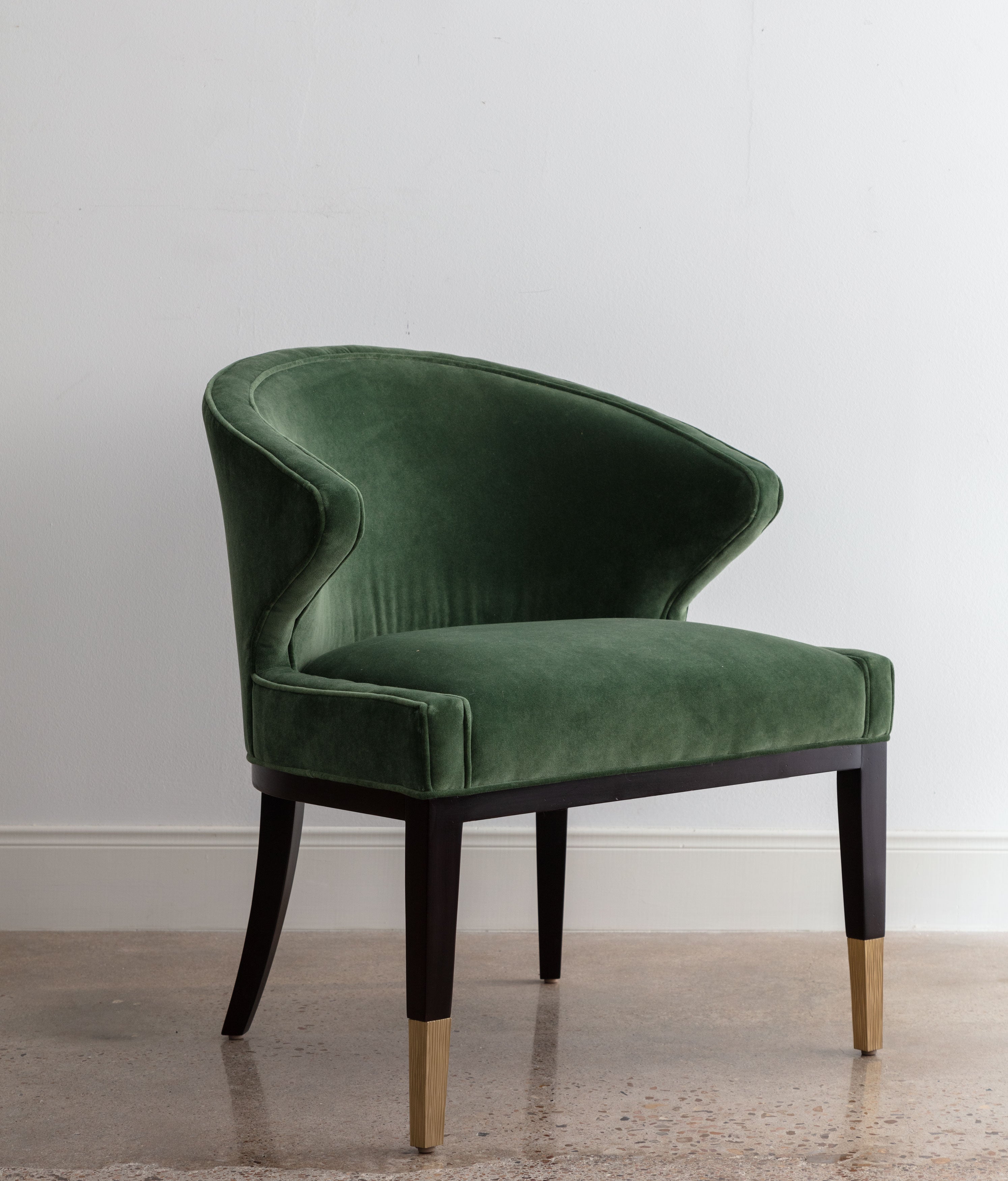 angled view of green velvet chair